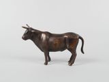 bronze figurine of a bull on a white background