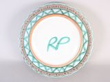 a picture of a decorative plate with the letter r on it