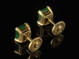 a pair of gold and emerald cufflinks