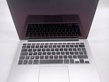 a close up of a laptop computer on a white surface