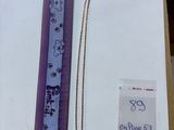 a picture of a ruler and a necklace in a box