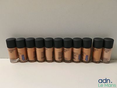 une rangée de produits de maquillage posés sur une surface blanche