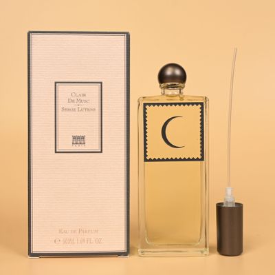 a bottle of perfume sitting next to a box of perfume