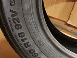 a close up of a tire on a wooden floor with boxes in the background