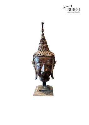 the head of a buddha statue on a marble base