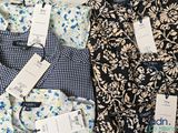 a lot of shirts that are sitting on a table