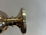a shiny metal door knob on the wall