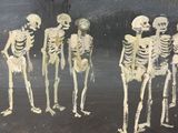 painting of a group of skeletons standing next to each other on a black surface