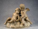 a statue of a boy and a girl sitting on a rock