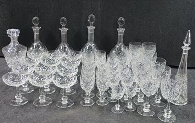 a lot of wine glasses and decanters sitting on a table