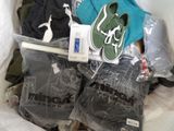 a bag full of clothes and a pair of shoes in it
