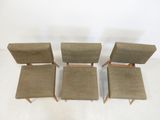 four mid century style chairs with upholstered back cushions