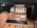 a cash register sitting on top of a wooden counter