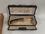 a box with a brush and a comb inside of it