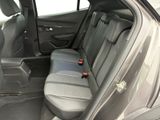 the back seats of a car with a bottle of wine in the passenger seat