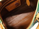 the inside of a green and yellow purse with a brown handle