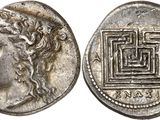 a silver coin with an image of a woman ' s face on it