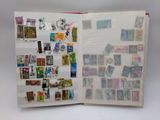 an open book with stamps on it on a table