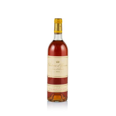 a bottle of wine sitting on top of a white surface