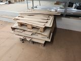 several pieces of wood are stacked on top of each other in a room