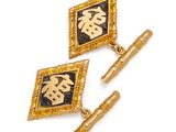 two pairs of gold and black enamel cufflinks with chinese characters