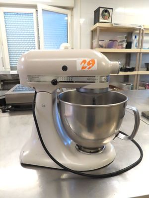 a white mixer sitting on a counter in a kitchen
