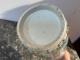 a person holding a glass of water in their hand