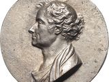 an old silver coin with a bust of a man on it
