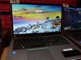 two laptops sitting side by side on a table