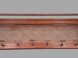 an old wooden rack with four pegs and four pegs on it
