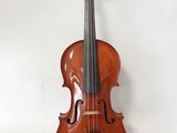 an old violin sitting on top of a white surface