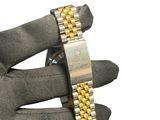 a person holding a watch in their right hand
