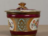 a small bowl with a lid sitting on a table