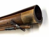 a close up of a wooden telescope mounted on a wall
