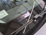 a close up of a car windshield with a sticker on it