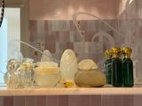 a counter with a lot of bottles and soaps on it