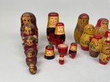 a lot of russian nesting dolls on a white surface