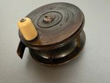 a small metal object with a yellow handle on a table