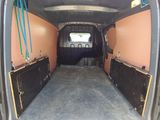 the inside of a van with the doors open and a horse in the back