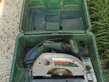 a green box that has a circular saw in it