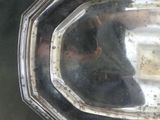 a silver tray with a silver handle on a table
