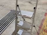 an image of a metal step stool in a warehouse