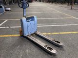 a forklift sitting in the middle of a parking lot
