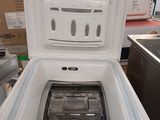 a white refrigerator with a lid open in a room