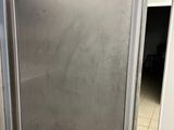 a stainless steel refrigerator in the corner of a kitchen