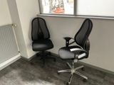 two office chairs in the corner of a room
