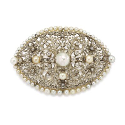 pearl and silver broochle with pearls on a white background