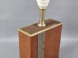 an old fashioned lamp on top of a wooden box on a gray surface