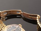 an image of a gold wrist watch with diamonds on the bracelet