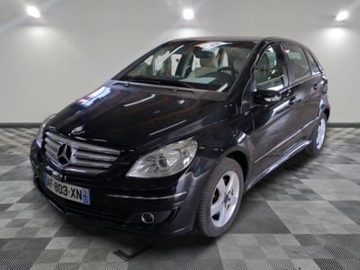 a picture of a black mercedes b - class parked on a checkered floor